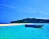 Traditional boat sailing through azure waters - explore hidden coves with customized Andaman packages