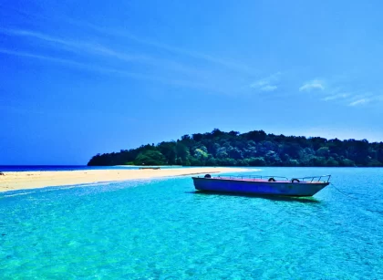 Traditional boat sailing through azure waters - explore hidden coves with customized Andaman packages