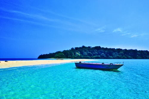 Traditional boat sailing through azure waters - explore hidden coves with customized Andaman packages
